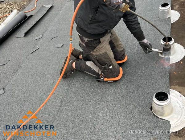 Dakdekker repareert bitumen dakleer bij dakdoorvoer in Winschoten Dakdekker repareert bitumen dakleer bij dakdoorvoer in Winschoten